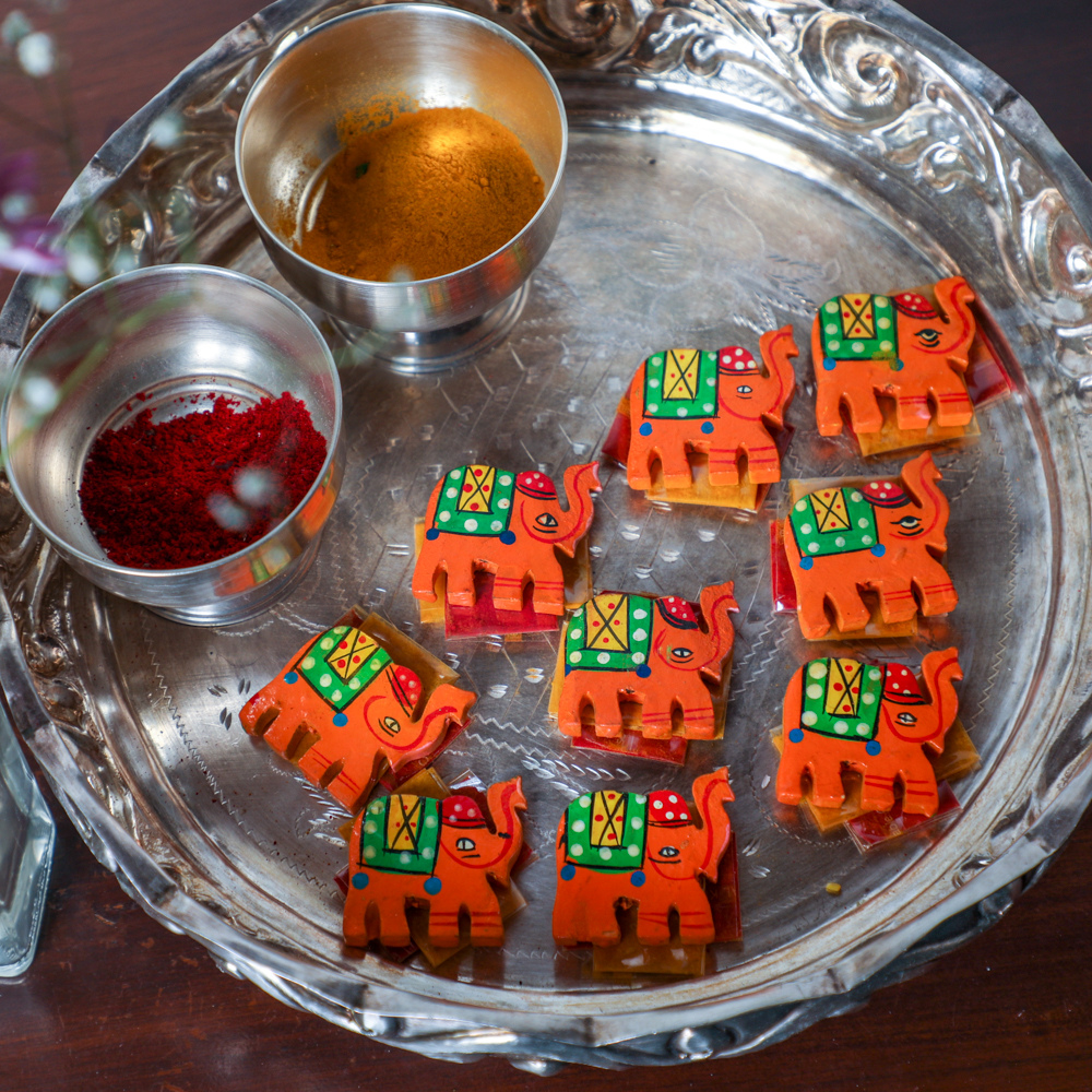 Haldi and kumkum sachets in a plate