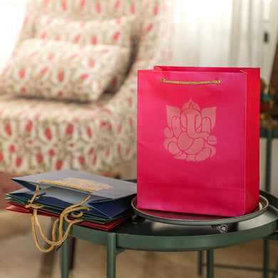 Pink return gift bag with golden Ganesha